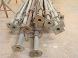 a pile of metal pipes and poles in a warehouse
