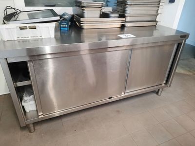 a stainless steel counter with a bunch of plates on it