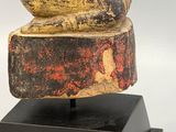 an image of a statue of a snake sitting on top of a wooden block