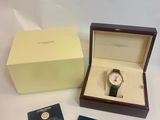 an image of a watch in a box and a business card