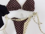 two pieces of bikini with polka dot print on them on a white surface