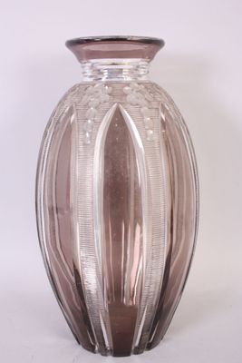 a glass vase that is sitting on a white surface