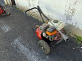 a small lawn mower parked on the side of the road