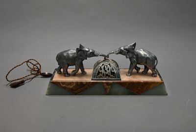two elephants that are standing on top of a piece of wood