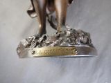 a bronze statue of a man riding a horse