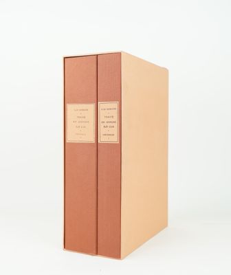 two books are stacked on top of each other on a white surface