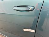 a close up of a car door handle with a sticker on it