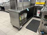a large kitchen with a lot of stainless steel appliances