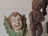 three figurines on a white table with a white background