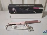 a pink hair dryer sitting on a table next to a box