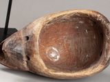 a wooden bowl that is sitting on a stand