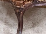 a close up of a chair with a yellow pillow on it