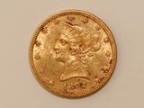 a close up of a gold coin on a white surface