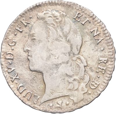 gros plan d'une pièce de monnaie sur laquelle figure une tête de femme
