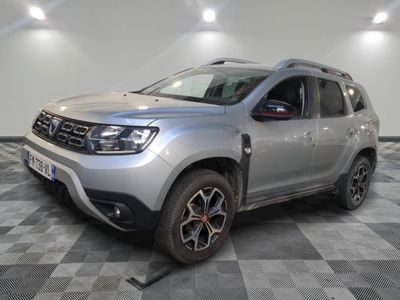 the grey dacia is parked on a checkered tile floor