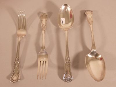 five silver spoons and two silver spoons on the table