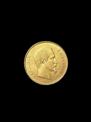 a close up of a gold coin on a black background