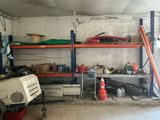 an image of a garage with a lot of things on the shelves