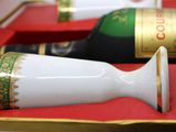two bottles of wine in a red box with gold trim