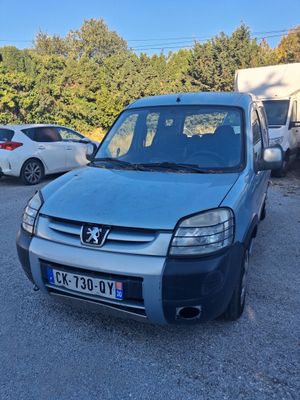 a small blue van parked in a parking lot