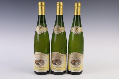 three bottles of wine sitting next to each other on a table