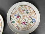 two plates with flowers on them on a table