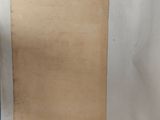 an old piece of paper sitting on top of a table next to a cup of coffee
