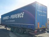 a large blue truck that is parked in a lot