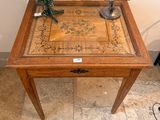 a small table with a flower on top of it