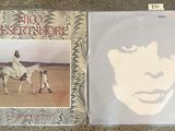 the album is on the floor next to a picture of a woman on a horse