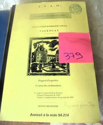 a yellow book with a pink sticker on it