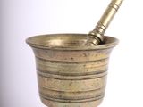 brass mortar and pest bowl on a white background