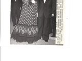a black and white photo of a man and woman at a formal event