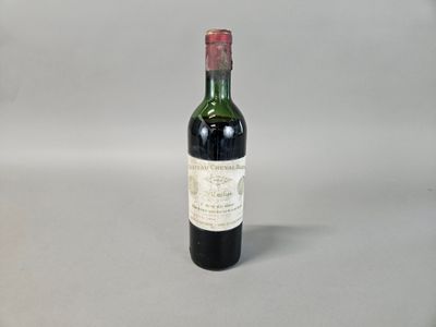 an old bottle of wine sitting on top of a table