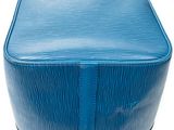 a close up of a blue bag on a white surface