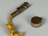 a small toy snake that is next to a metal object