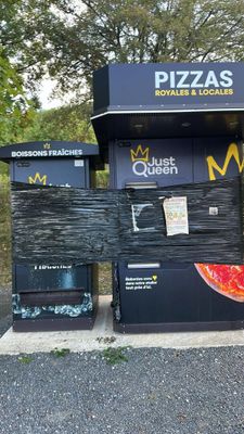 a pizza kiosk on the side of the road