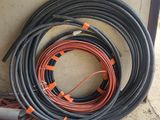 a bunch of hoses are sitting on the ground next to a wall