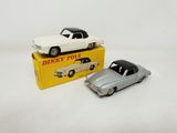 two toy cars are sitting on top of a yellow box