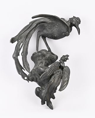 sculpture représentant un oiseau perché sur une branche, avec un autre oiseau perché sur son dos