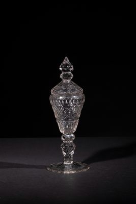 a clear glass vase sitting on top of a black table