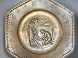 a gold plate with a picture of a woman and a man
