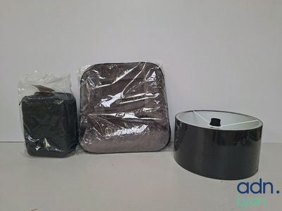 a bag and a roll of black tape on a table