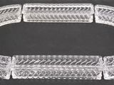 a close up of a clear glass bracelet on a black surface