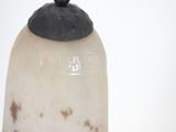 a white vase with a black top on a table