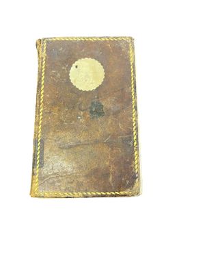 an old book with a picture of a tree on the cover