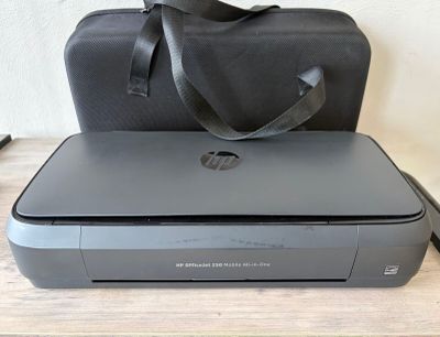un sac noir posé sur une imprimante grise