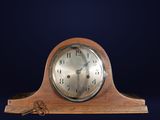 a wooden clock with a key on top of it
