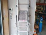 a ladder that is leaning against a wall in a garage