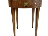 a small round table with a drawer on one side and a drawer on the other